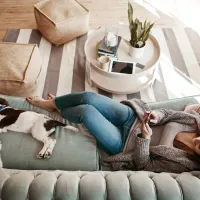 lady sitting on the couch with her dog