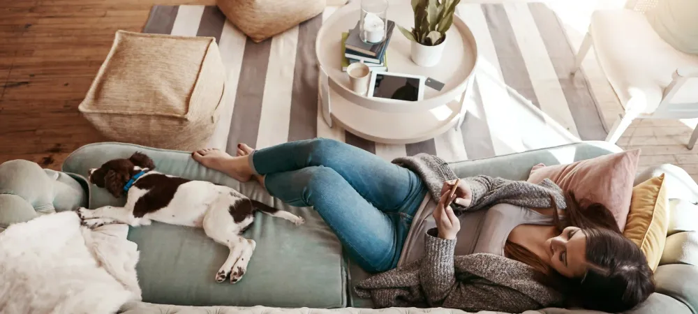 lady sitting on the couch with her dog